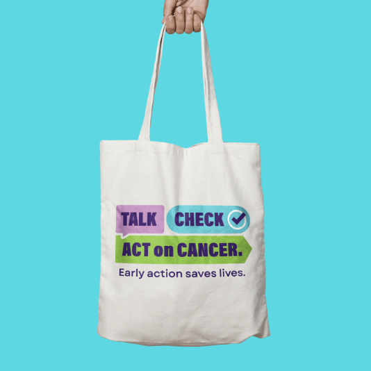 White tote bag featuring the Talk Check Act on Cancer campaign logo